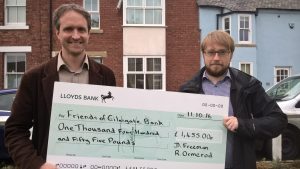 Cllr Richard Ormerod (left) presents the cheque for the new benches